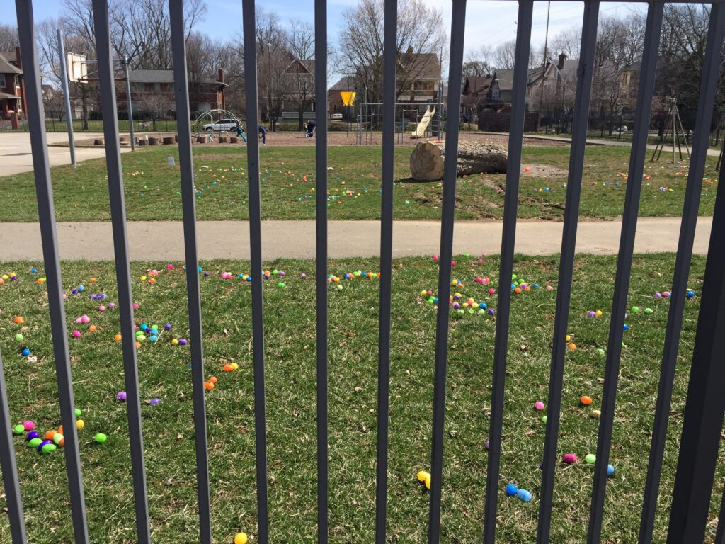 Colorful Easter eggs scattered across a grassy playground, ready for the egg hunt.
